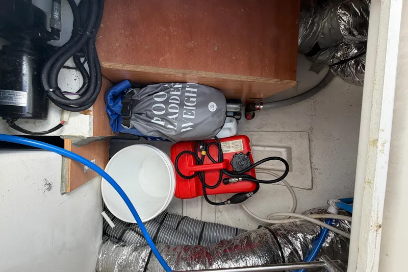 Slide: The Image of Storage compartment in a 2016 Beneteau Oceanis 48 yacht with equipment and hoses. - 54