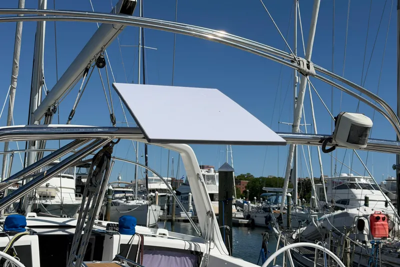 Slide: The Image of Beneteau Oceanis 48 sailboat, 2016 model, docked at marina with clear blue sky. - 58
