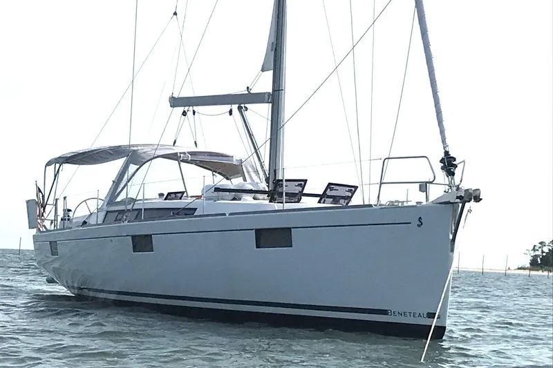 Slide: The Image of 2016 Beneteau Oceanis 48 sailboat on calm waters, showcasing sleek design and modern features. - 59