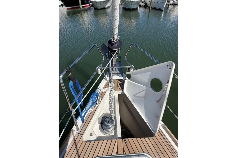 Slide: The Image of Bow of 2016 Beneteau Oceanis 48 sailboat with anchor chain and open hatch. - 8