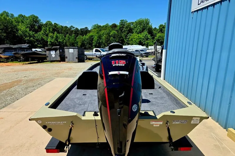 Slide: The Image of 2026 Tracker Pro Team 190 boat with Mercury 115 Pro XS engine, parked outdoors. - 10