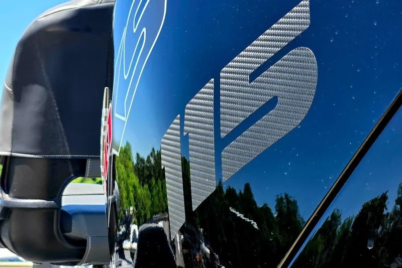Slide: The Image of Close-up of 2026 Tracker Pro Team 190 boat with reflective surface and carbon fiber detail. - 15
