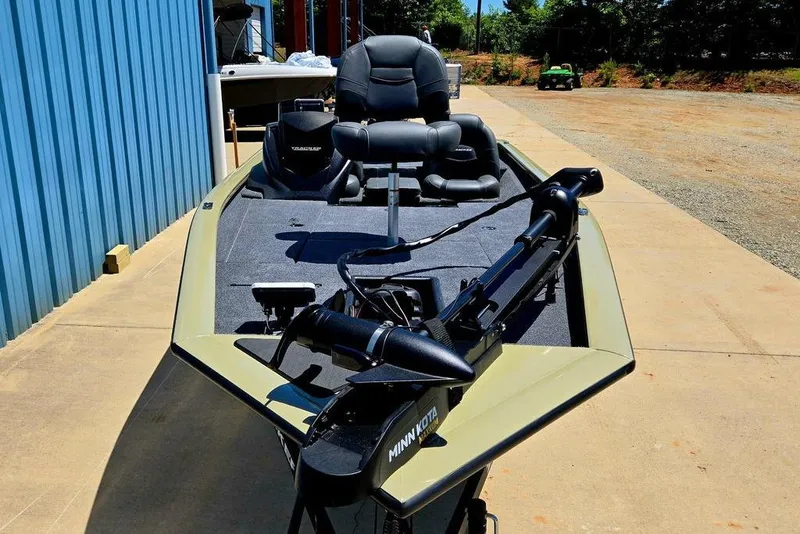 Slide: The Image of 2026 Tracker Pro Team 190 boat with Minn Kota trolling motor, parked outdoors. - 17