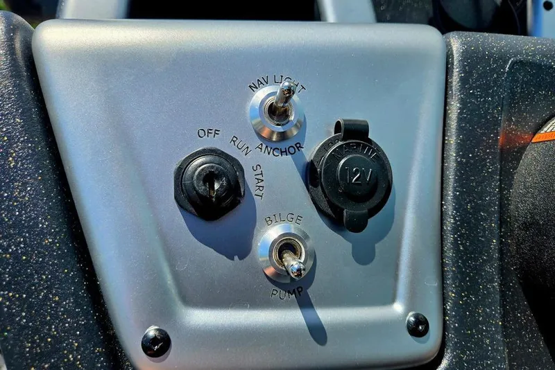 Slide: The Image of Control panel of 2026 Tracker Pro Team 190 boat with switches and 12V outlet. - 36