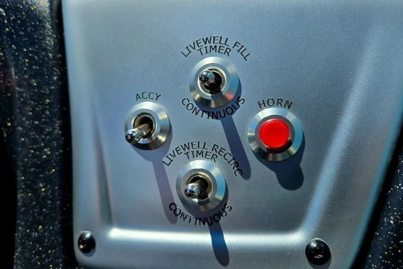 Slide: The Image of Control panel of 2026 Tracker Pro Team 190 boat with switches and horn button. - 39