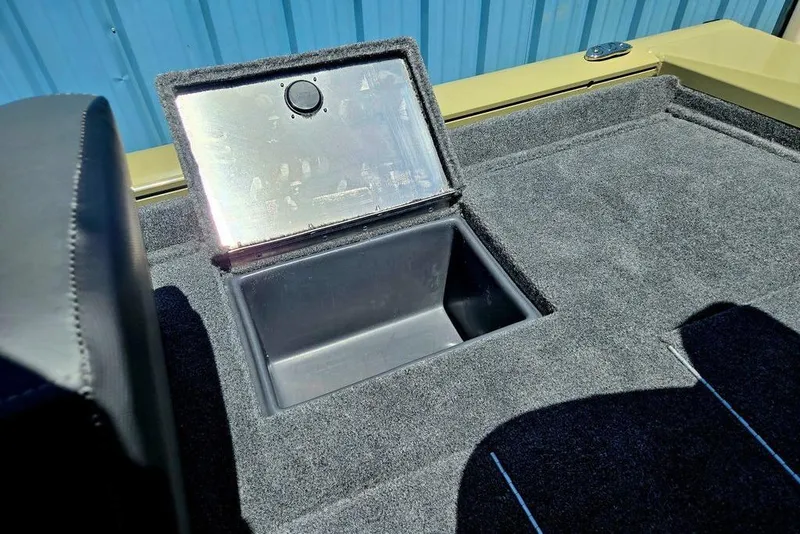 Slide: The Image of 2026 Tracker Pro Team 190 boat storage compartment with open lid, showcasing interior space. - 44