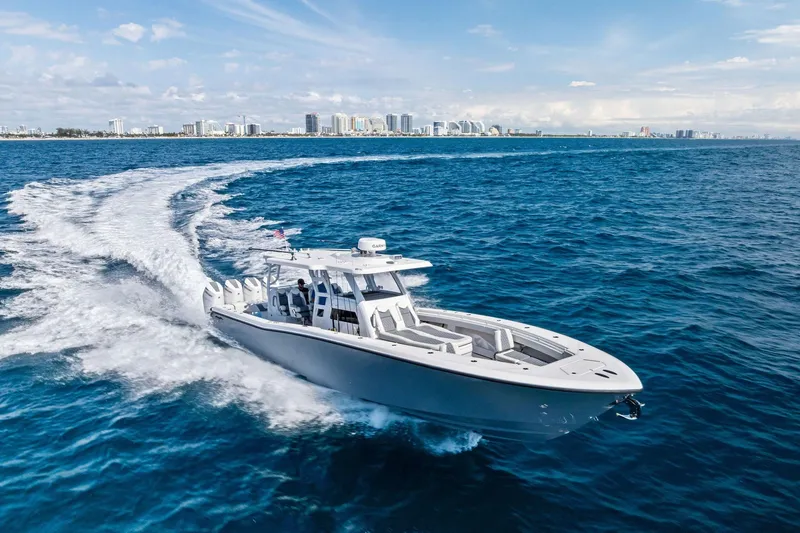 The Image of 2024 Invincible 43 Open Fisherman cruising on blue ocean near city skyline. - 0