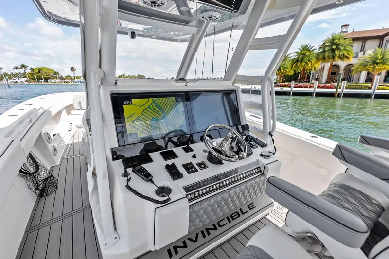 Slide: The Image of 2024 Invincible 43 Open Fisherman boat cockpit with advanced navigation system and luxurious seating. - 11