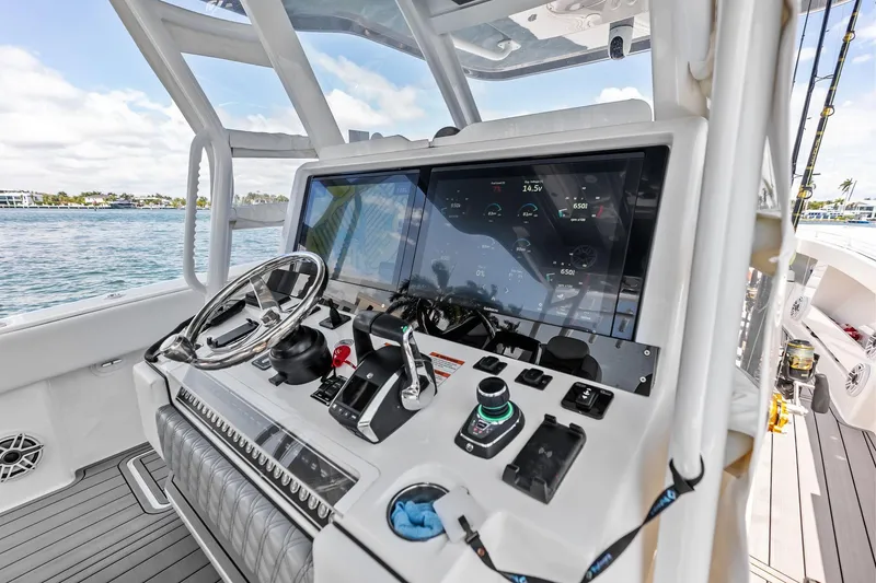 Slide: The Image of 2024 Invincible 43 Open Fisherman helm with advanced navigation controls and sleek design. - 12