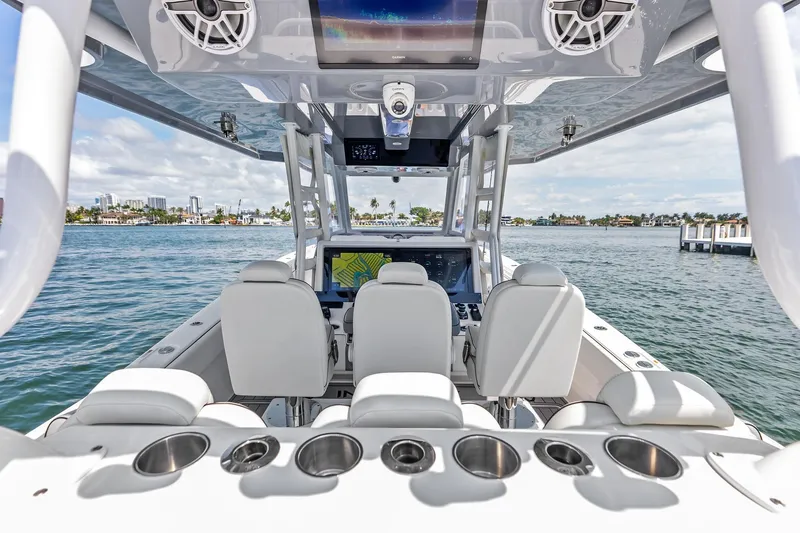 Slide: The Image of 2024 Invincible 43 Open Fisherman boat interior with helm and seating on the water. - 15