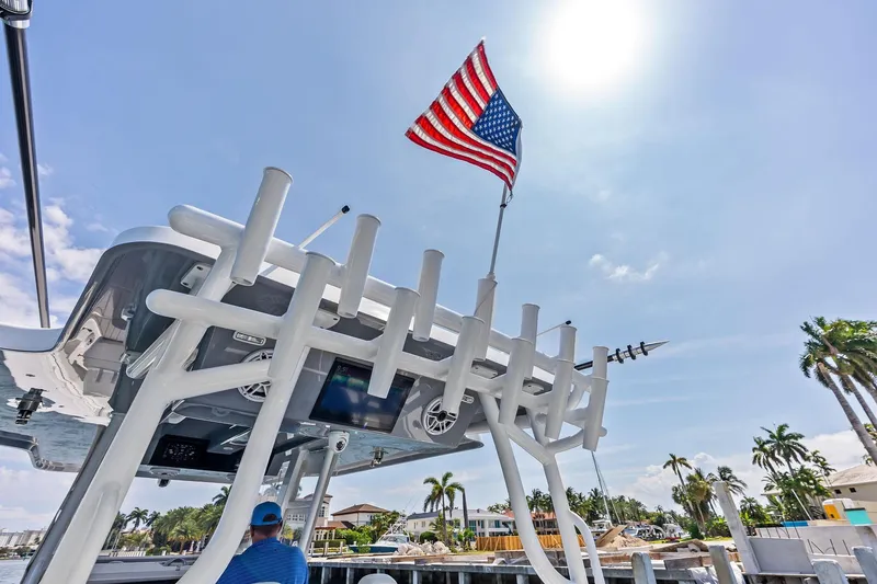 Slide: The Image of 2024 Invincible 43 Open Fisherman with American flag under sunny sky. - 20