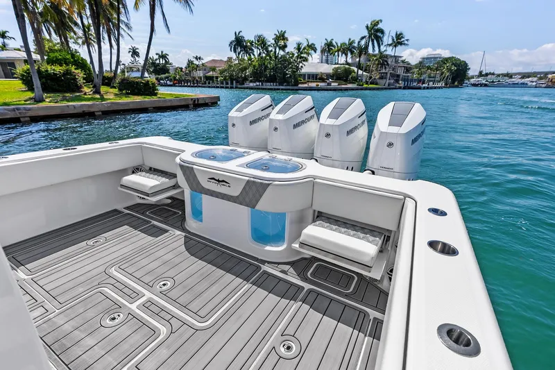 Slide: The Image of 2024 Invincible 43 Open Fisherman boat with quad Mercury engines on a sunny waterway. - 26