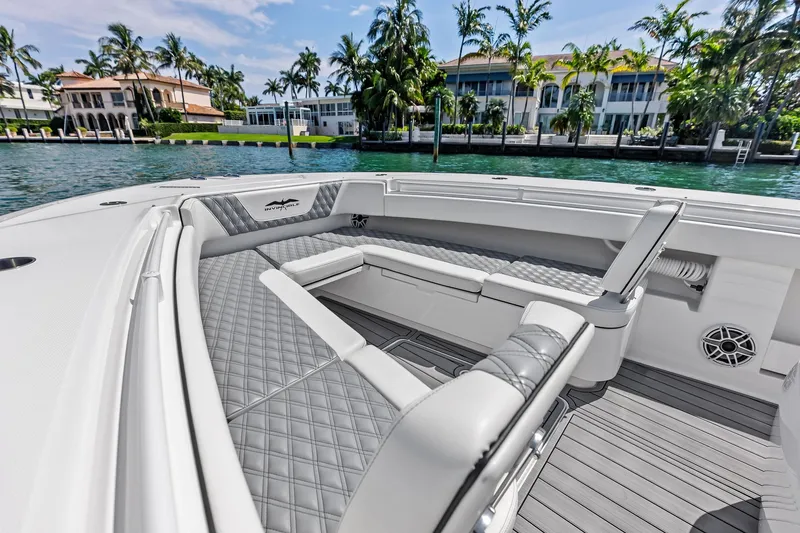 Slide: The Image of 2024 Invincible 43 Open Fisherman boat interior with luxurious seating and waterfront view. - 32