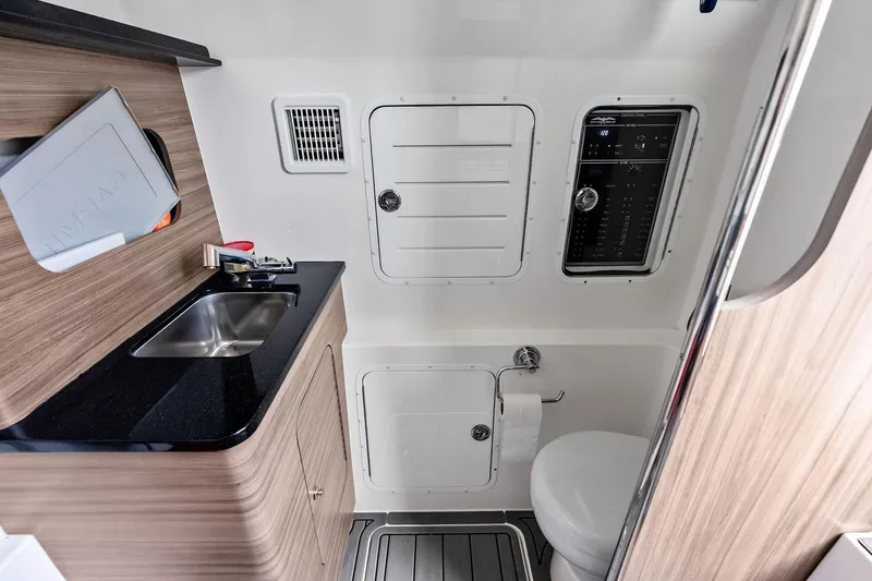 Slide: The Image of 2024 Invincible 43 Open Fisherman boat interior with sink, toilet, and control panel. - 39