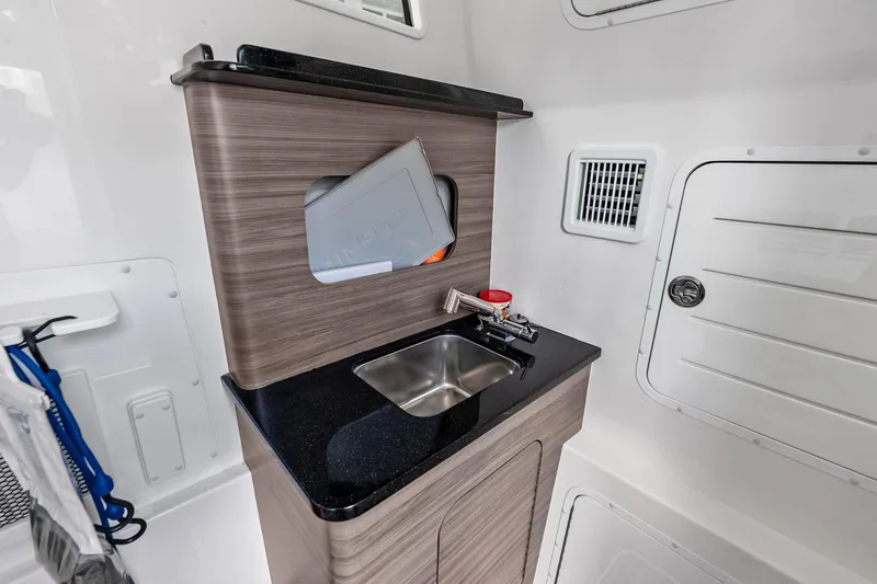 Slide: The Image of 2024 Invincible 43 Open Fisherman interior with sleek sink and modern cabinetry. - 40