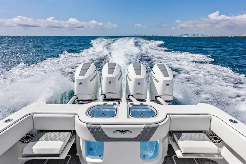 Slide: The Image of 2024 Invincible 43 Open Fisherman boat with four powerful engines cruising on open water. - 44