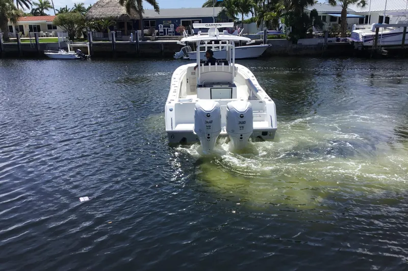 Slide: The Image of 2024 Sea Hunt Gamefish 28 Coffin Box boat cruising in a canal with twin engines. - 12