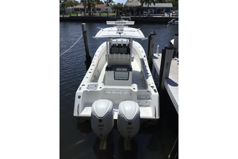Slide: The Image of 2024 Sea Hunt Gamefish 28 Coffin Box boat docked with twin engines. - 15