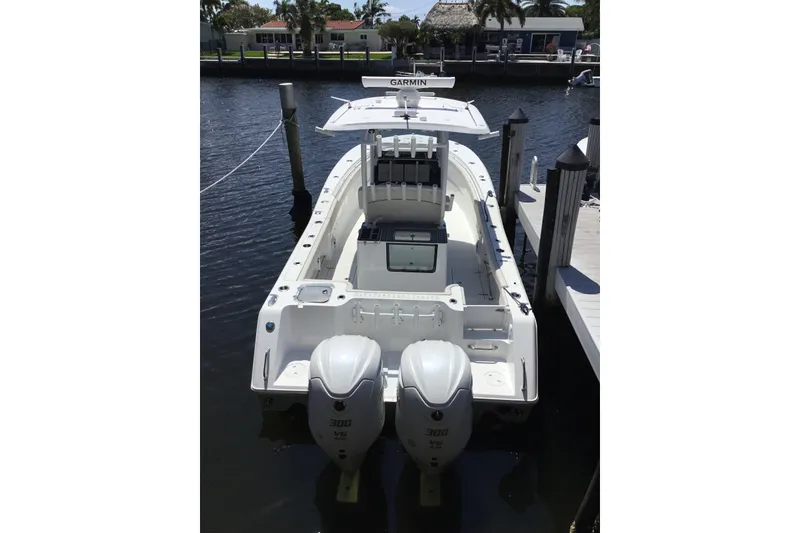 Slide: The Image of 2024 Sea Hunt Gamefish 28 Coffin Box boat docked with twin engines. - 16