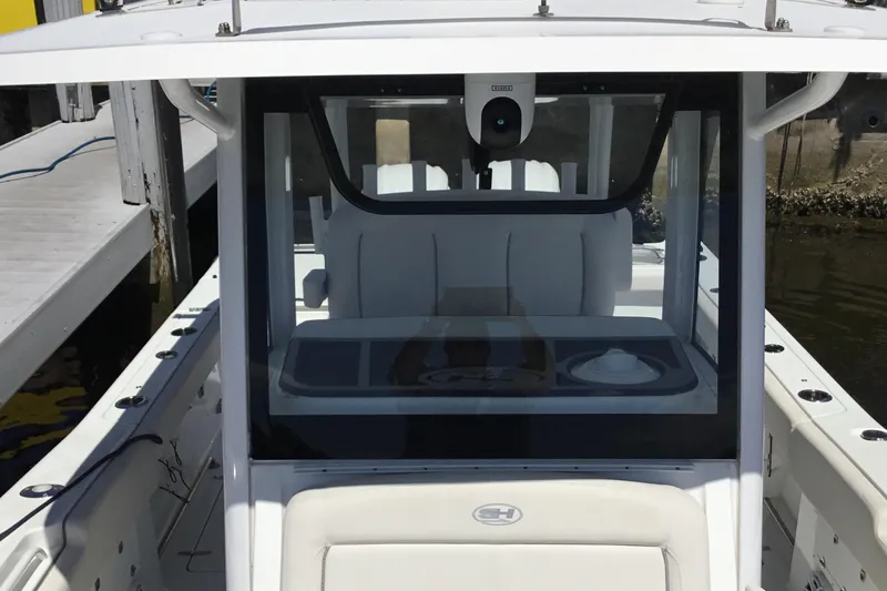 Slide: The Image of 2024 Sea Hunt Gamefish 28 Coffin Box boat interior with helm and seating. - 18