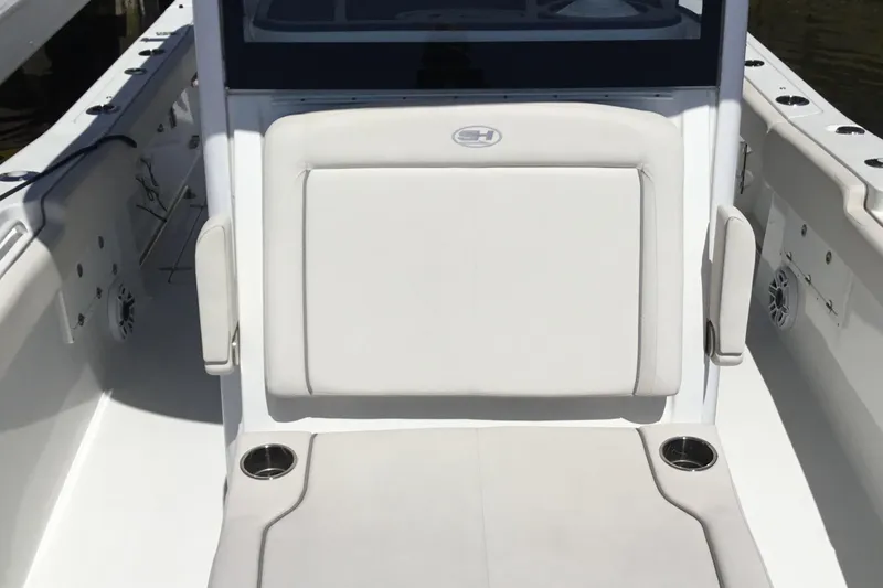 Slide: The Image of 2024 Sea Hunt Gamefish 28 Coffin Box boat interior with cushioned seating and cup holders. - 19