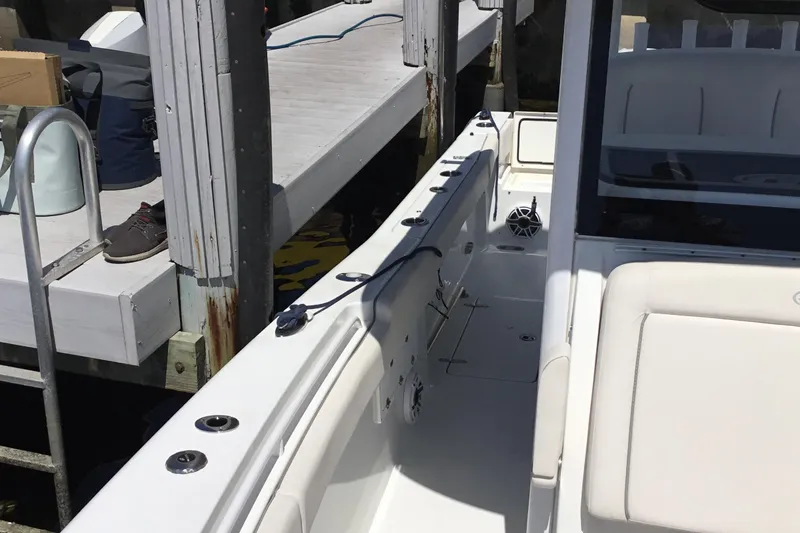 Slide: The Image of 2024 Sea Hunt Gamefish 28 Coffin Box boat docked, featuring spacious seating and sleek design. - 20