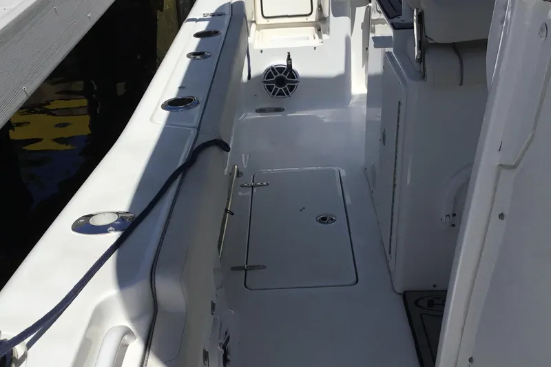 Slide: The Image of 2024 Sea Hunt Gamefish 28 Coffin Box interior with storage compartments and seating. - 27