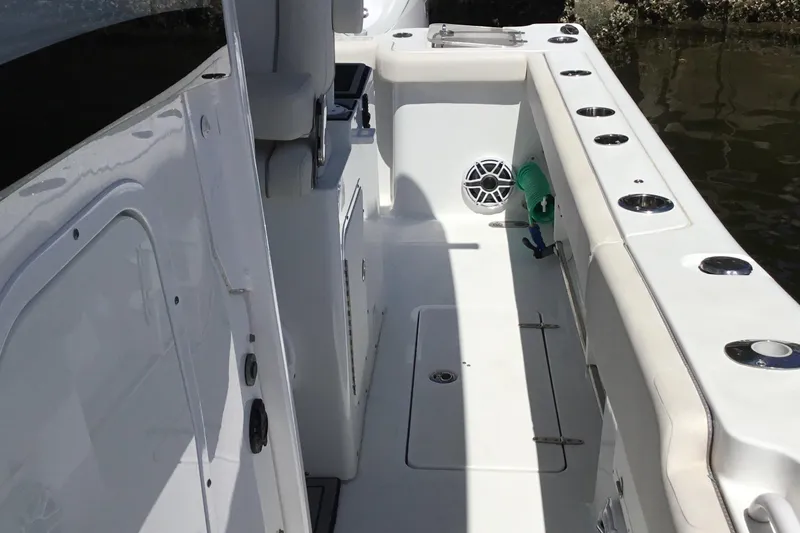 Slide: The Image of 2024 Sea Hunt Gamefish 28 Coffin Box boat interior with rod holders and storage. - 28