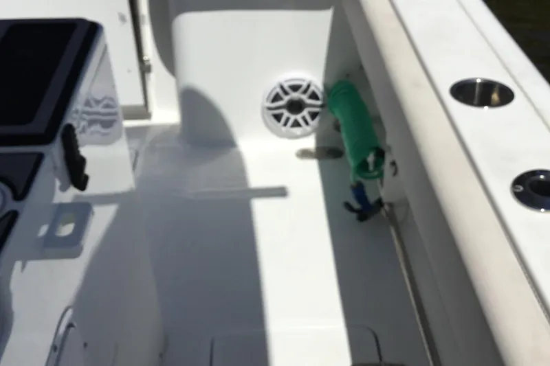 Slide: The Image of 2024 Sea Hunt Gamefish 28 Coffin Box interior with rod holders and speaker. - 29