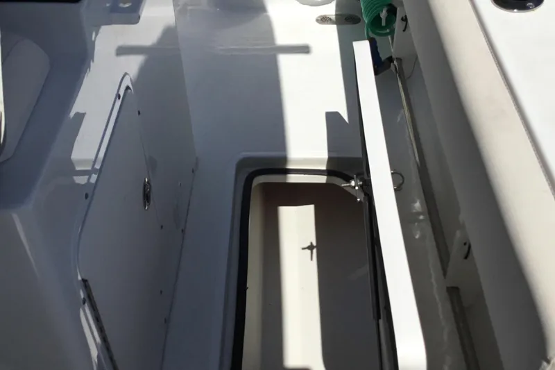 Slide: The Image of 2024 Sea Hunt Gamefish 28 Coffin Box interior, showcasing storage compartment and sleek design. - 30