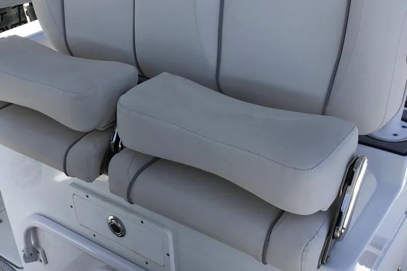 Slide: The Image of 2024 Sea Hunt Gamefish 28 Coffin Box boat seating detail, featuring cushioned armrests. - 31