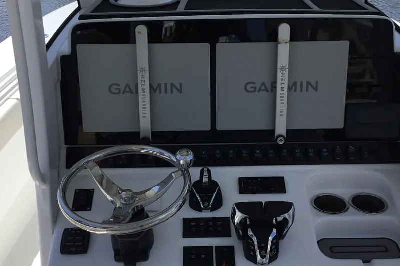 Slide: The Image of 2024 Sea Hunt Gamefish 28 Coffin Box helm with Garmin displays and controls. - 36