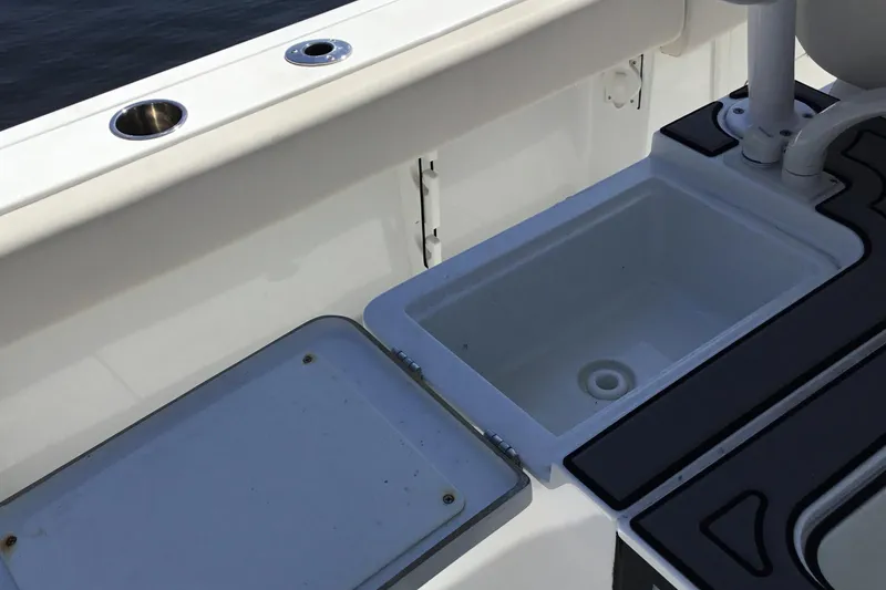 Slide: The Image of 2024 Sea Hunt Gamefish 28 Coffin Box interior with sink and storage compartment. - 39