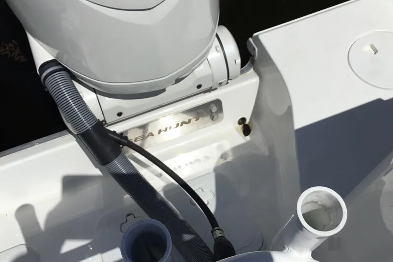Slide: The Image of 2024 Sea Hunt Gamefish 28 Coffin Box boat engine area with visible branding. - 42