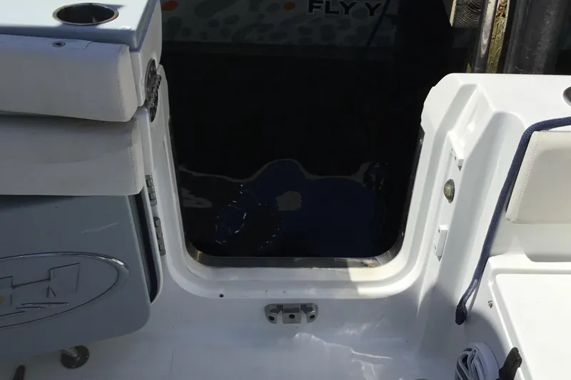 Slide: The Image of 2024 Sea Hunt Gamefish 28 Coffin Box boat interior with open hatch and seating. - 44