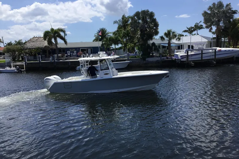 Slide: The Image of 2024 Sea Hunt Gamefish 28 Coffin Box cruising on a sunny waterfront. - 5
