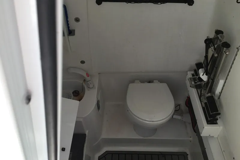 Slide: The Image of 2024 Sea Hunt Gamefish 28 Coffin Box boat interior with compact marine toilet. - 51