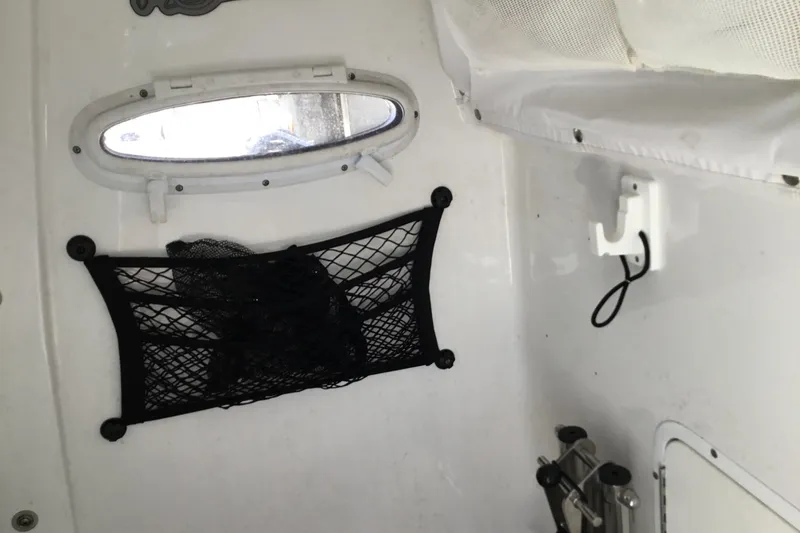 Slide: The Image of Interior of 2024 Sea Hunt Gamefish 28 Coffin Box with storage net and porthole. - 52