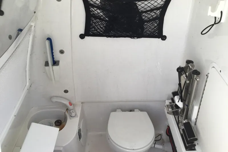 Slide: The Image of 2024 Sea Hunt Gamefish 28 Coffin Box boat interior with toilet and sink. - 53