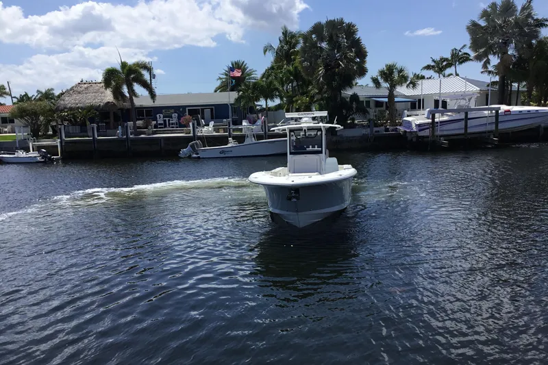 Slide: The Image of 2024 Sea Hunt Gamefish 28 Coffin Box cruising in a scenic waterfront setting. - 8