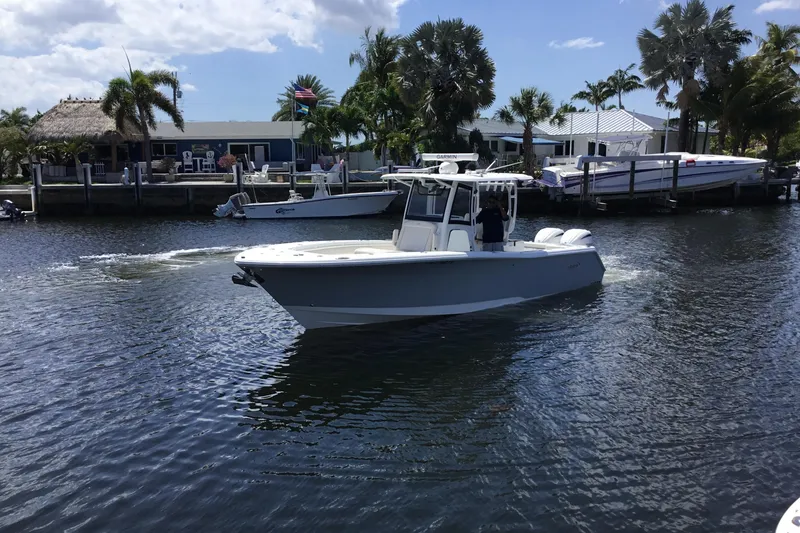 Slide: The Image of 2024 Sea Hunt Gamefish 28 Coffin Box boat cruising on a sunny waterway. - 9