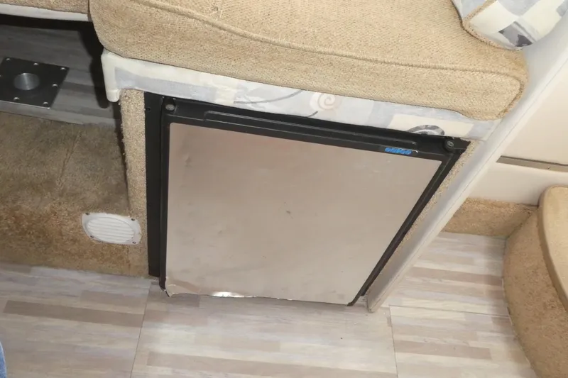 Slide: The Image of Interior of 2002 Bayliner 2855 Ciera featuring a compact built-in refrigerator. - 12