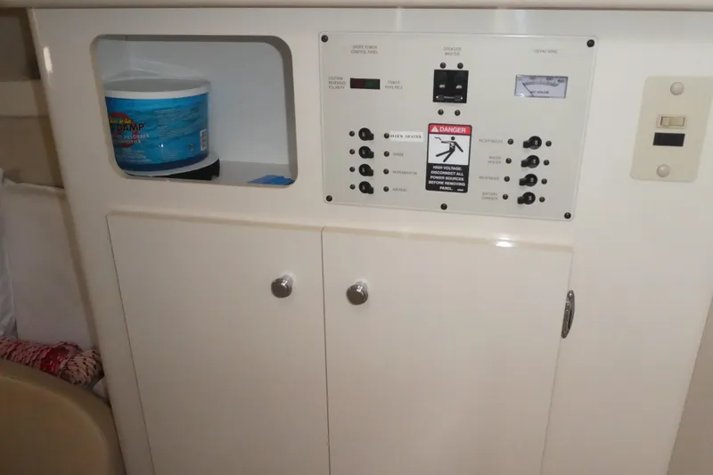 Slide: The Image of 2002 Bayliner 2855 Ciera control panel with storage compartment and safety warning. - 16