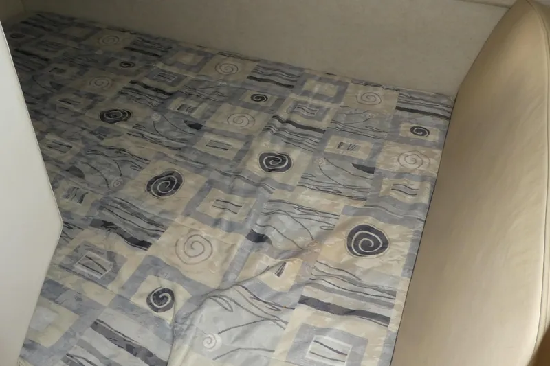 Slide: The Image of Interior cabin bed of 2002 Bayliner 2855 Ciera with patterned bedding. - 17