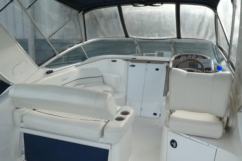 Slide: The Image of 2002 Bayliner 2855 Ciera boat interior with white seating and dashboard. - 2