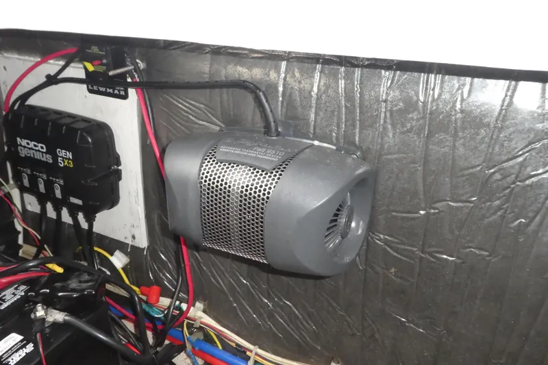 Slide: The Image of Electrical components inside a 2002 Bayliner 2855 Ciera boat, featuring a NOCO Genius charger. - 23
