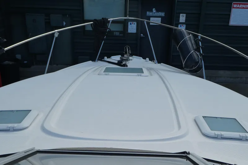 Slide: The Image of 2002 Bayliner 2855 Ciera boat deck with railing and hatches, docked at marina. - 25