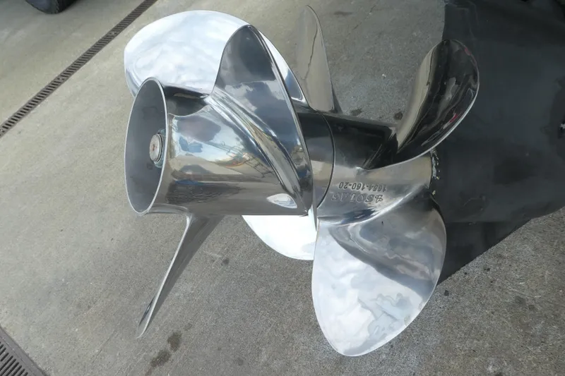 Slide: The Image of Shiny stainless steel boat propeller for 2002 Bayliner 2855 Ciera on concrete surface. - 27