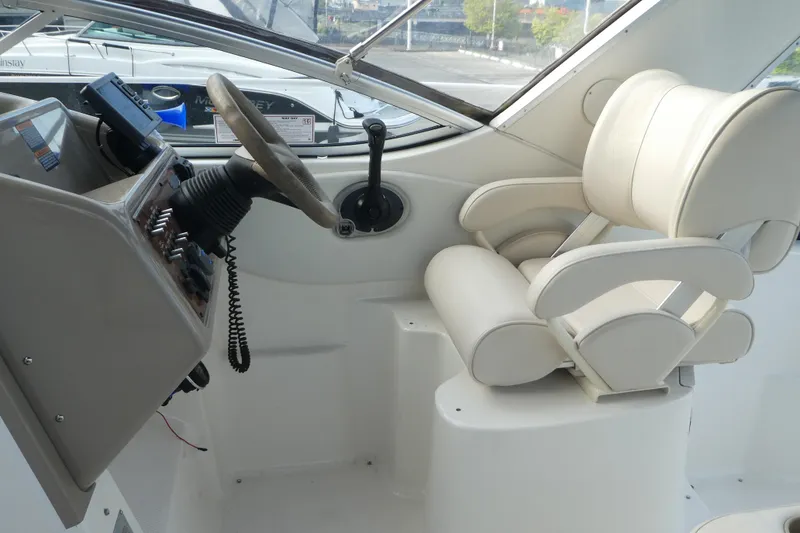 Slide: The Image of Helm of 2002 Bayliner 2855 Ciera with steering wheel and white captain's chair. - 3