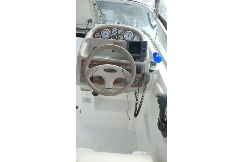 Slide: The Image of 2002 Bayliner 2855 Ciera helm with steering wheel, gauges, and navigation equipment. - 4